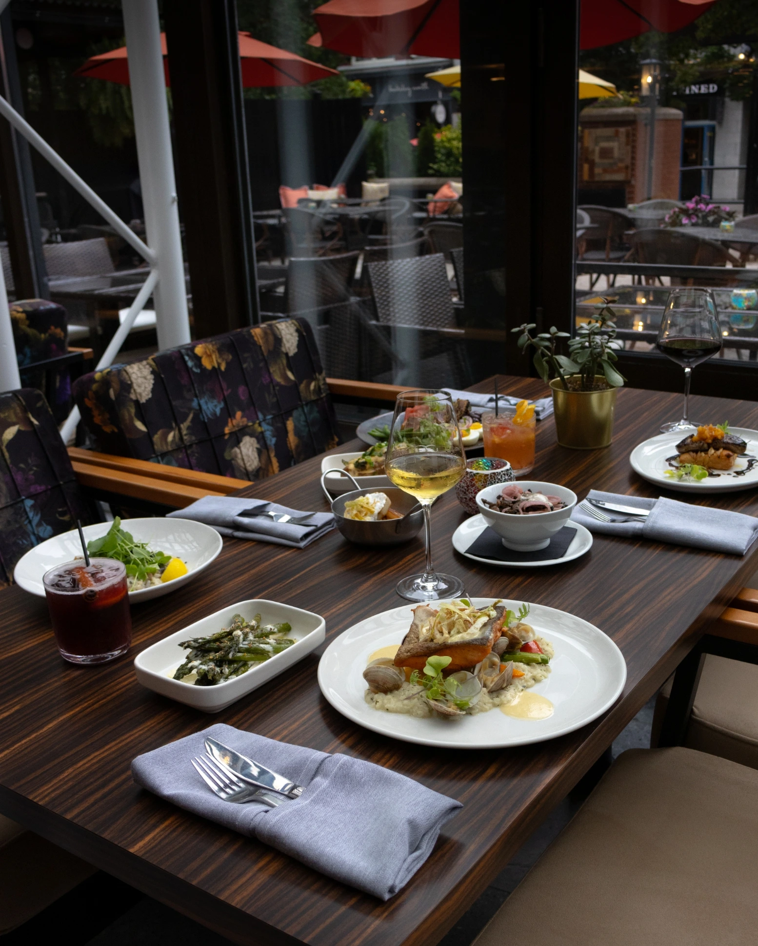 A neatly set table with Steak & Seafood dishes at Conversate Restaurant in Hamilton